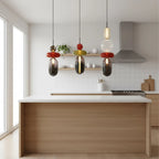 Trio of Glass Totem Pendant Lights Over Kitchen Island
