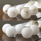 Comparison View of Alabaster Stone Texture and Frosted Glass Globes