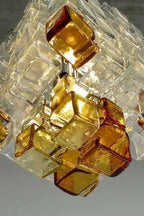 Close Up View of Illuminated Amber Glass Blocks Chandelier