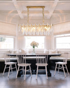 Modern Brass Linear Feather Chandelier Over Dining Nook