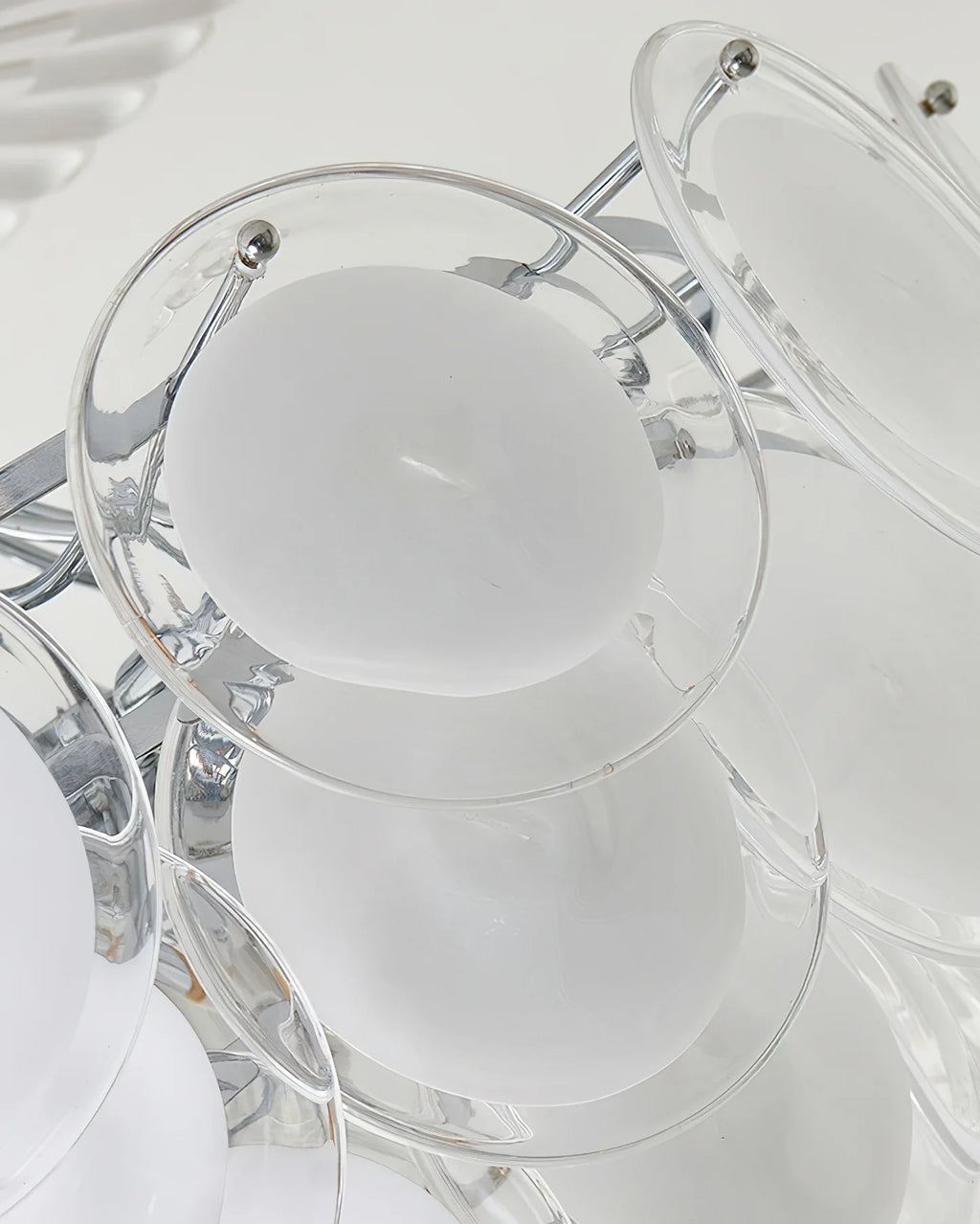 Close Up View of White Disc Glass Shades and Silver Metal Connector Structure