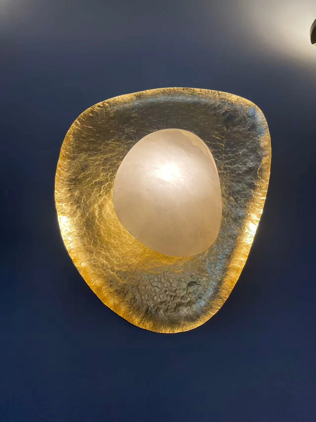 Gold Foil Pebble Alabaster Sconce Studio Display on Dark Blue Wall