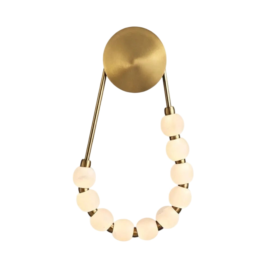 Modern Brass and Beaded Glass Wall Sconce with Warm Light on Pure White Background