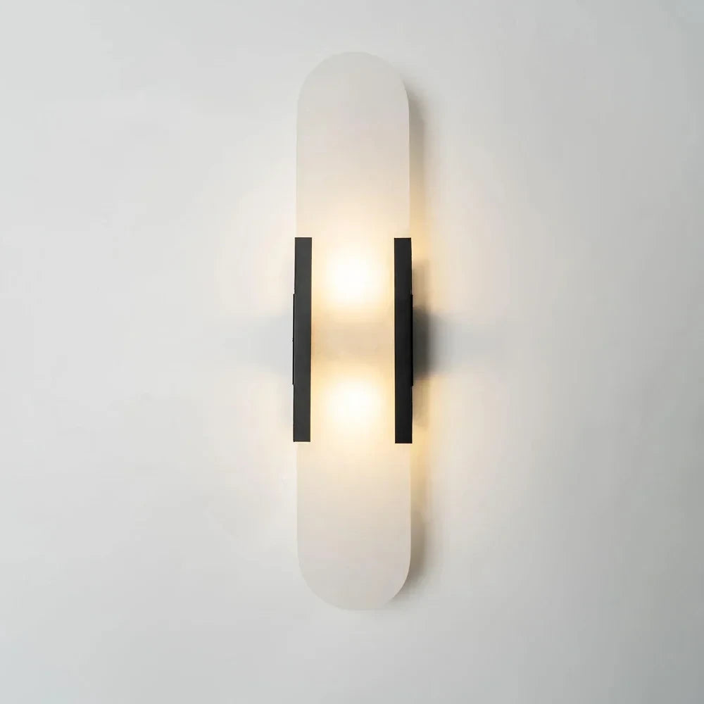 Side View of Illuminated Modern Capsule Alabaster Wall Sconce with Black Frame