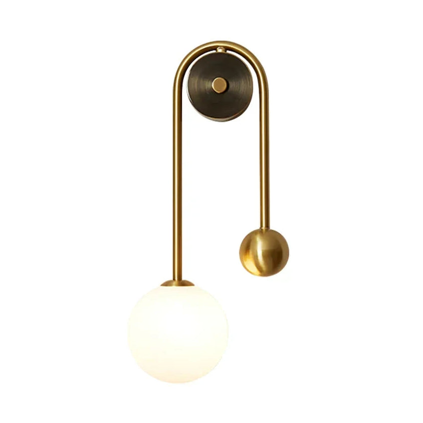 Modern Brass Curved Tube and Glass Globe Wall Sconce with Warm Light on Pure White Background