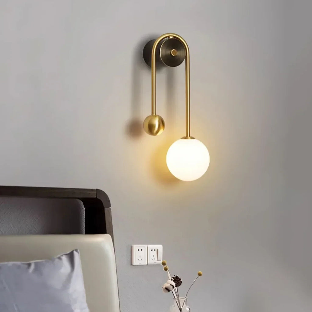 Modern Glass Globe Wall Sconce in Cozy Bedroom Interior