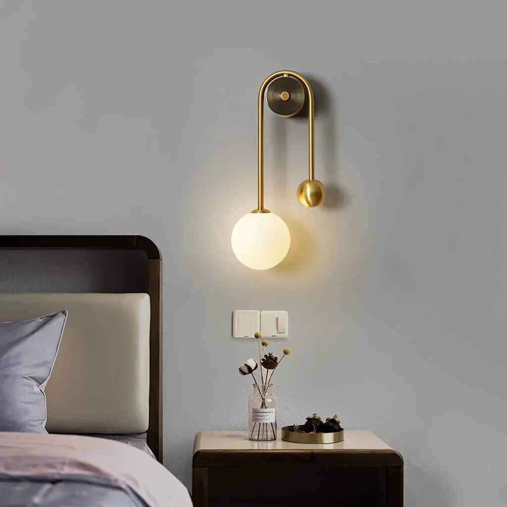 Modern Brass Globe Wall Sconce in Cozy Bedroom Setting