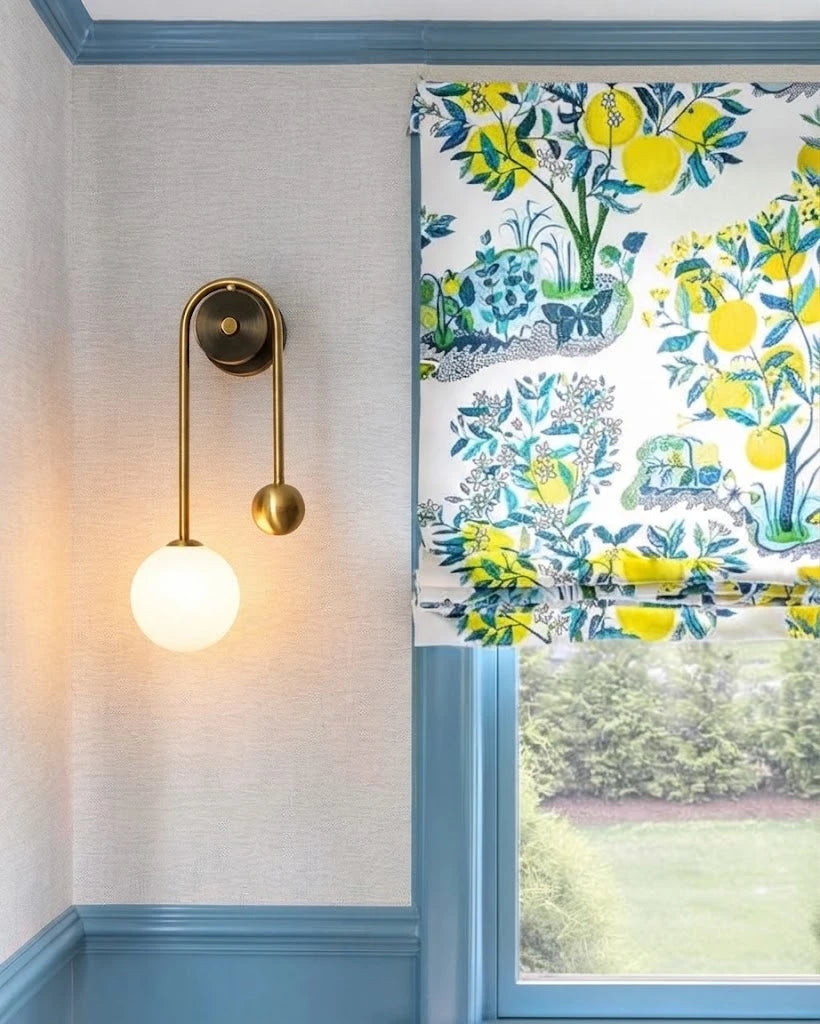 Modern Brass Curved Tube Wall Sconce in Bright Interior Setting