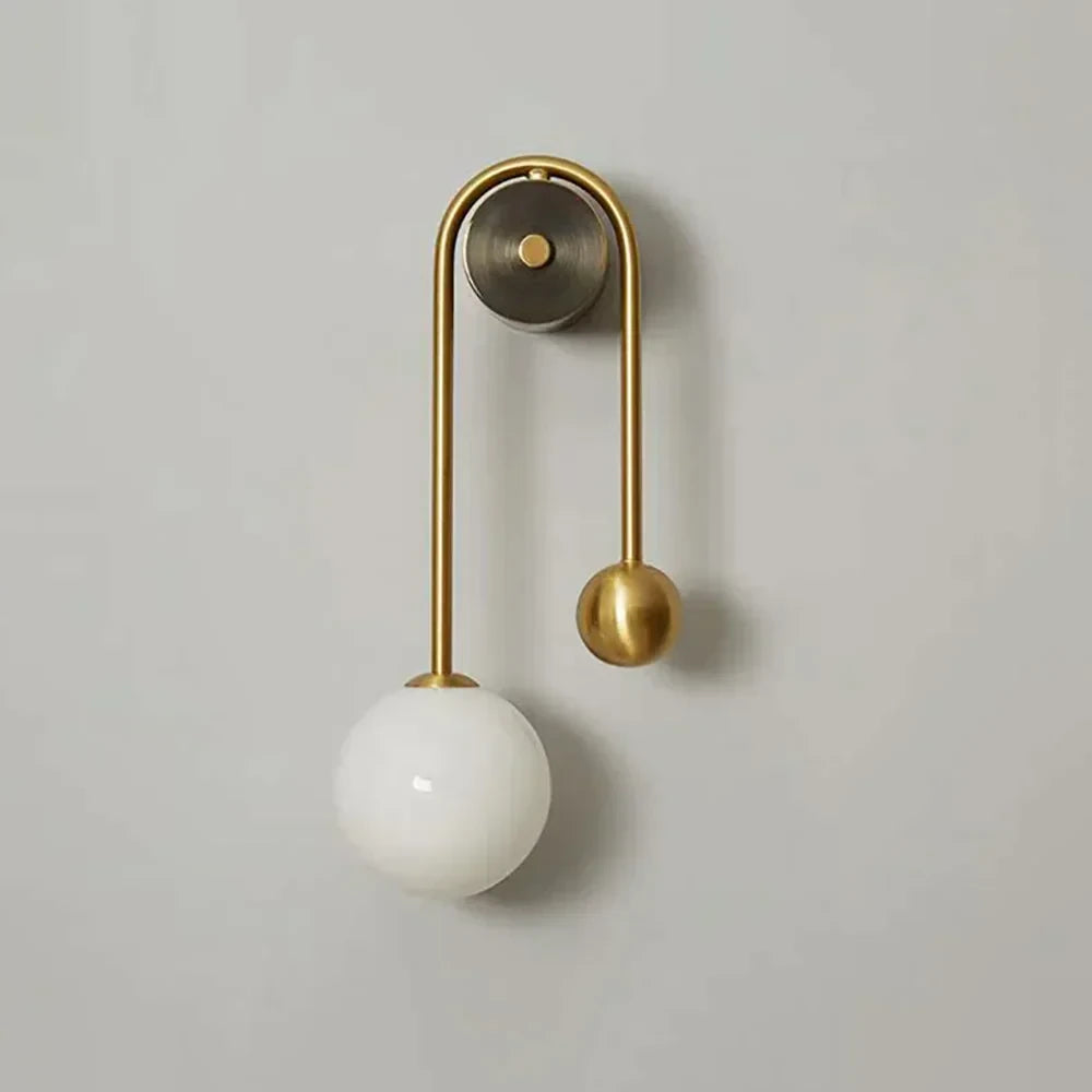 Illuminated Modern Brass Curved Tube Wall Sconce Studio Shot on White Background