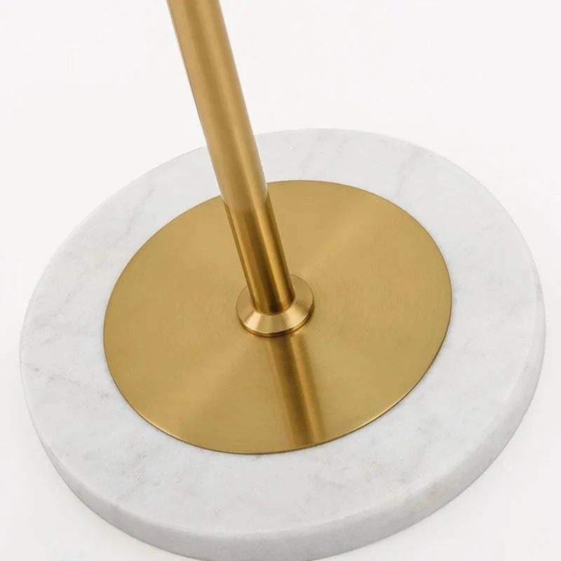 Close Up View of White Marble Base and Brass Pole Connection