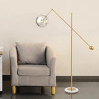 Modern Balance Arm Floor Lamp Beside Grey Armchair