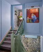 Modern Black Linear Picture Light Over Artwork in Stairway Hallway