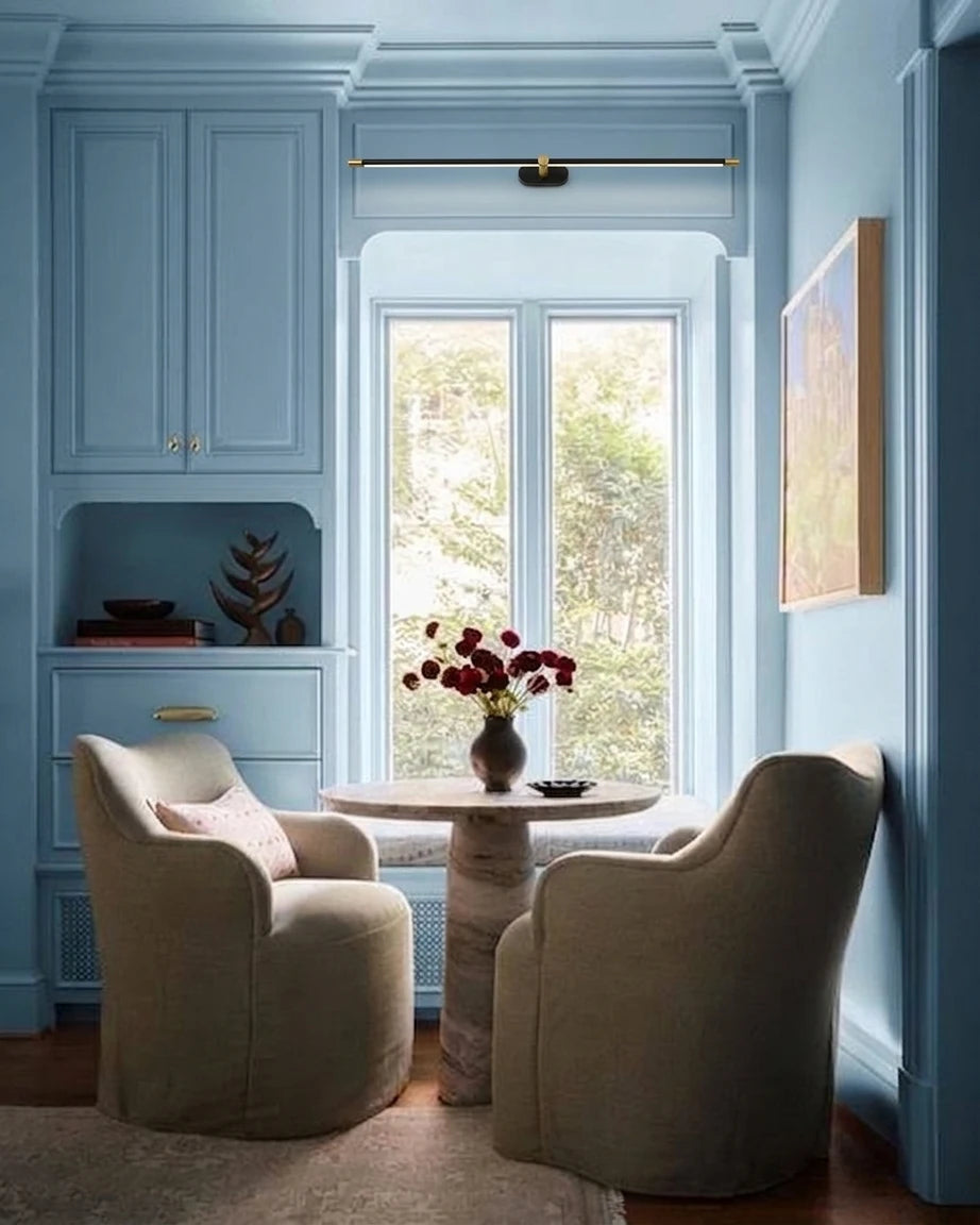 Modern Black Wall Sconce in Cozy Blue Living Area