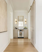 Modern Alabaster Glass Wall Sconce Along Hallway Corridor