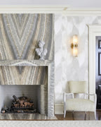 Modern Dual-Cylinder Wall Sconce Over Living Room Fireplace