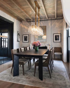 Modern Brass Linear Chandelier Over Dining Room Table