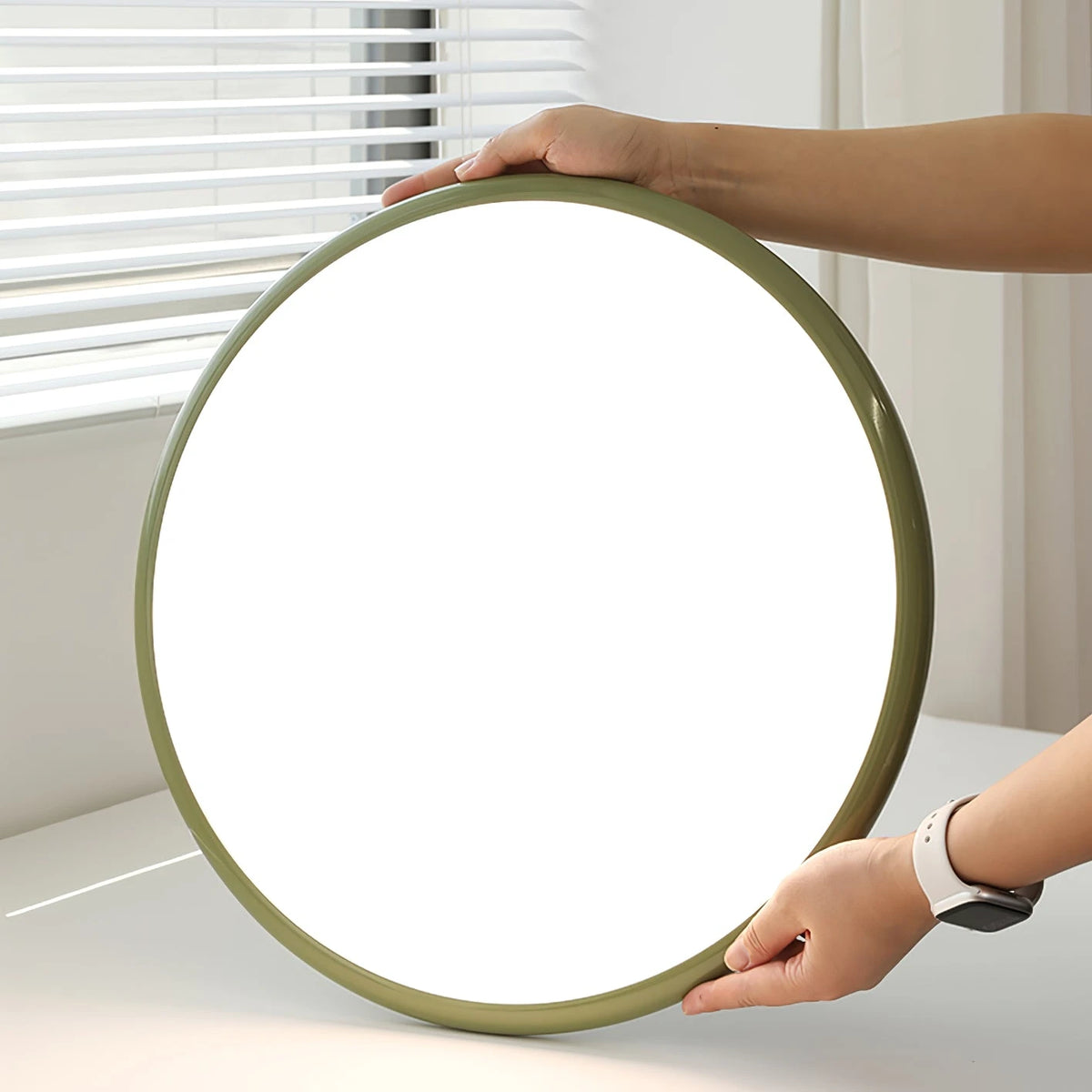 Hands Holding Modern Green Ultra-Thin Round Ceiling Light Fixture