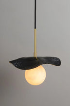 Side View of Illuminated Modern Black Disc Pendant Light