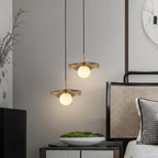 Modern Black and Gold Pendant Lights Over Master Bedside