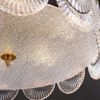 Bottom Up View of Illuminated Faceted Glass Ceiling Light and Ceiling Patterns
