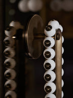 Close Up View of White Beads and Brass Structure Details