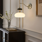 Vintage Wall Sconce with Pull Chain Over Storage Cabinet