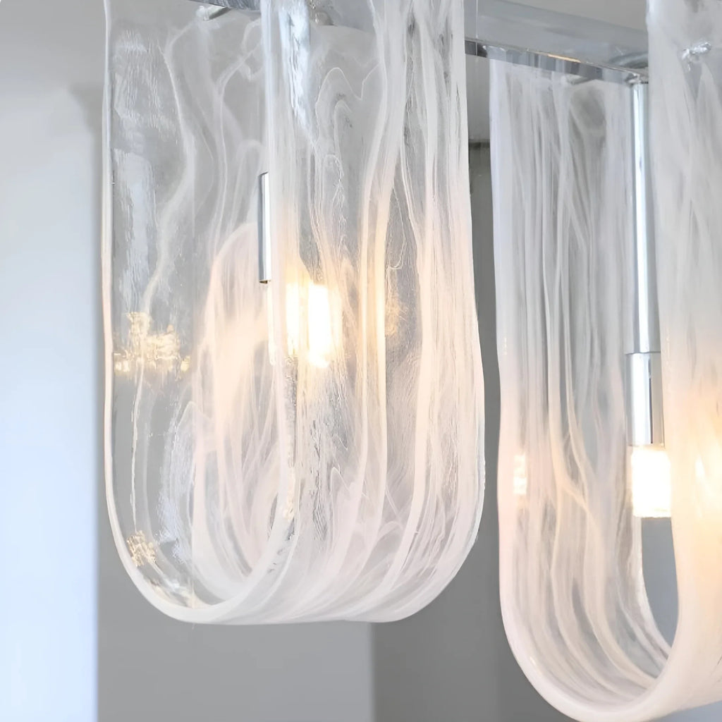 Close Up View of Illuminated Linear Glass Chandelier Studio Shot