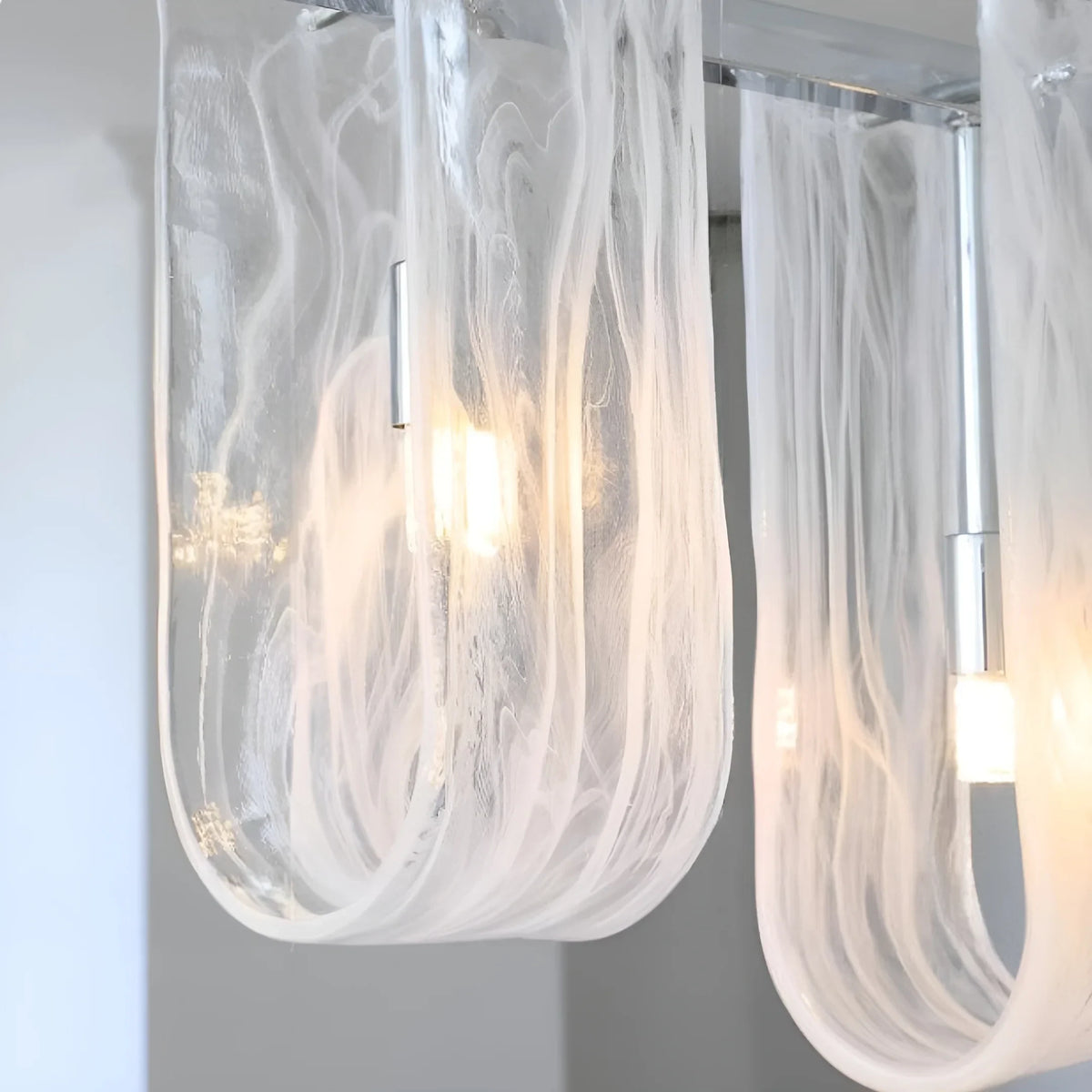 Close Up View of Illuminated Linear Glass Chandelier Studio Shot