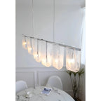 Modern Linear Glass Pendant Light Over Dining Table Setting