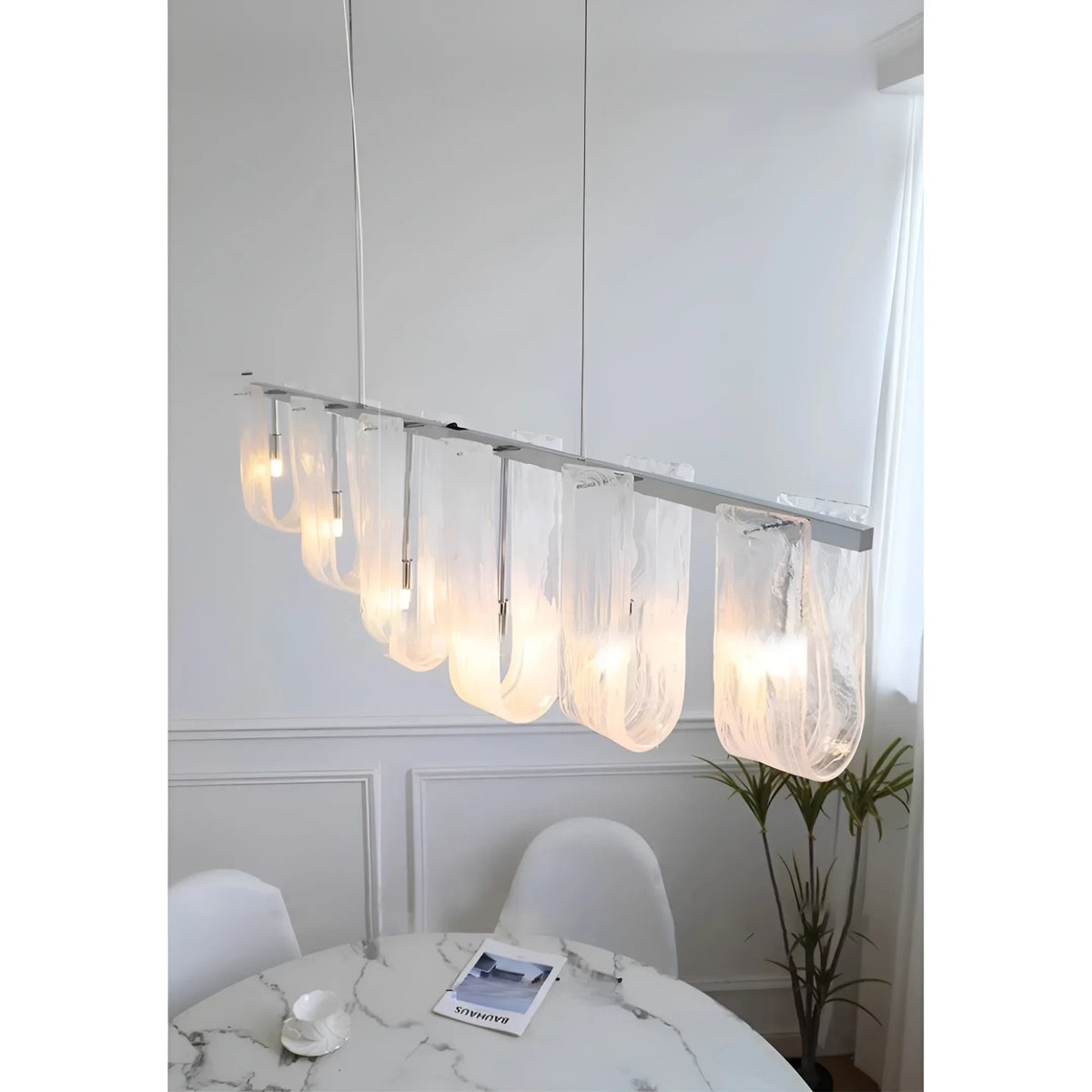 Modern Linear Glass Pendant Light Over Dining Table Setting