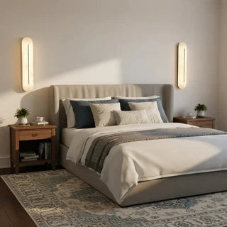 Pair of Oval Alabaster Wall Sconces Flanking Bedroom Bed