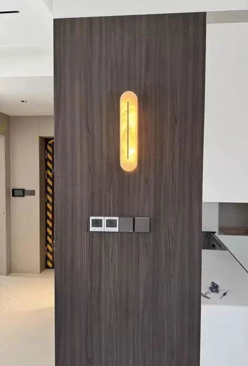 Capsule Alabaster LED Wall Light Mounted on Wood Panel Wall
