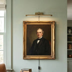 Traditional Brass Picture Light Over Portrait in Gallery Wall