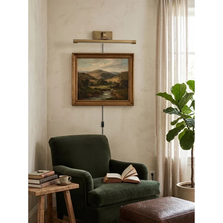 Modern Brass Plug-in Wall Sconce Over Artwork in Reading Nook