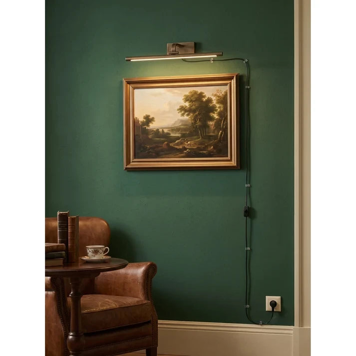 Traditional Brass Picture Light Against Green Accent Wall
