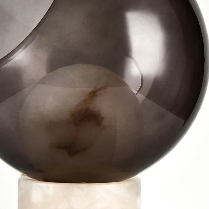 Close Up View of Illuminated Smoked Grey Cut-Sphere Glass and Internal Warm Glow Details