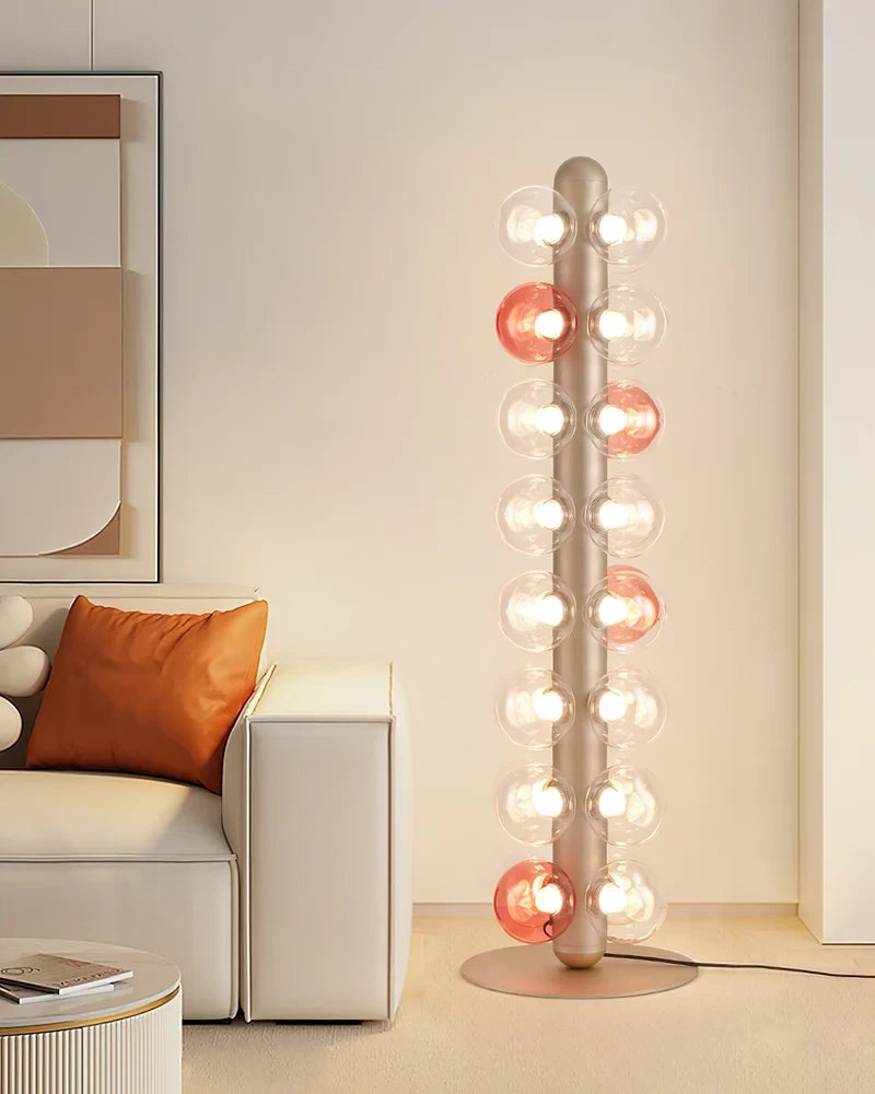 Modern Brass Post Globe Floor Lamp Next to Living Room Sofa