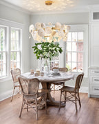 Modern White Round Plate Art Glass Chandelier Over Wooden Dining Table