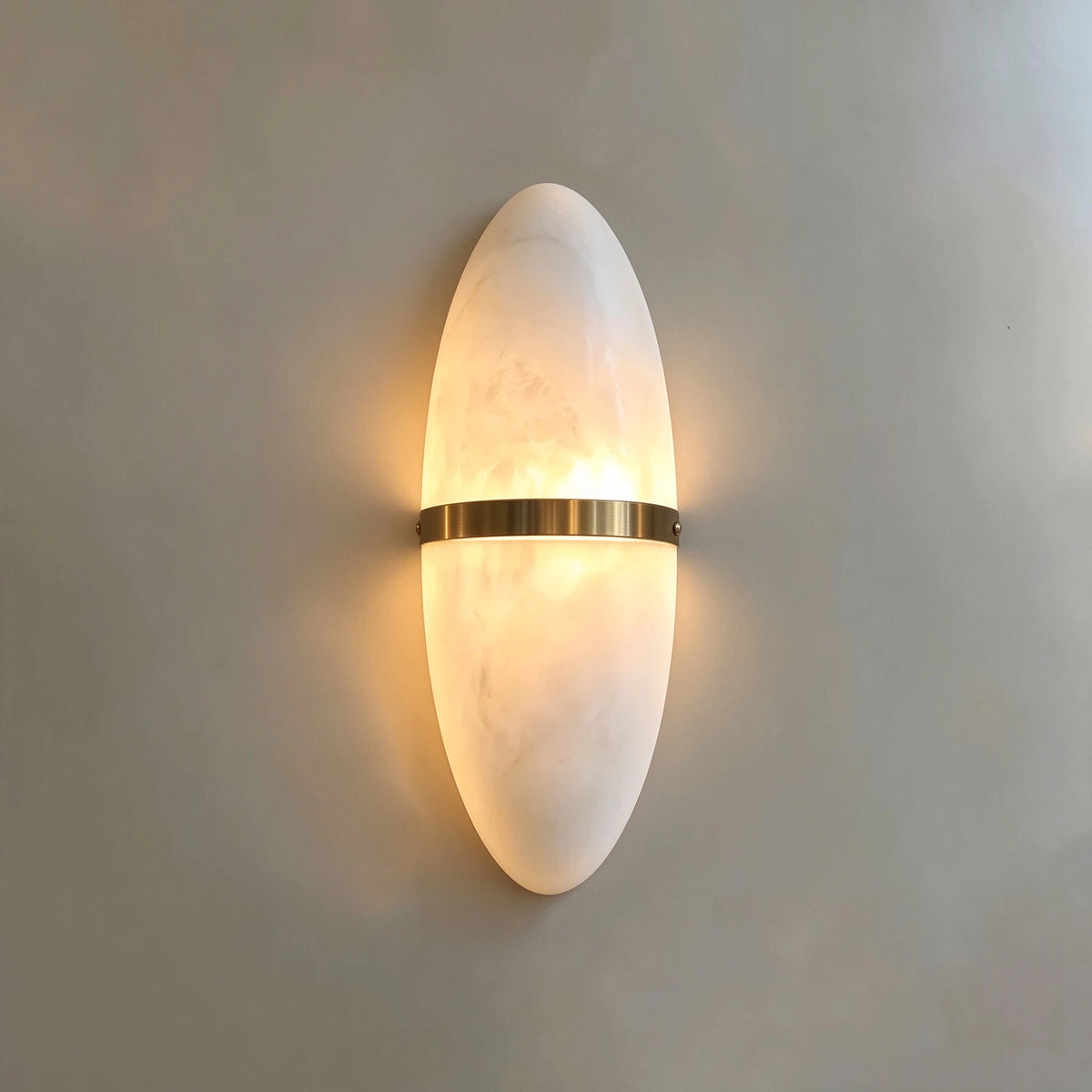Illuminated Modern Oval Alabaster Wall Sconce Studio Shot on Pure White Background
