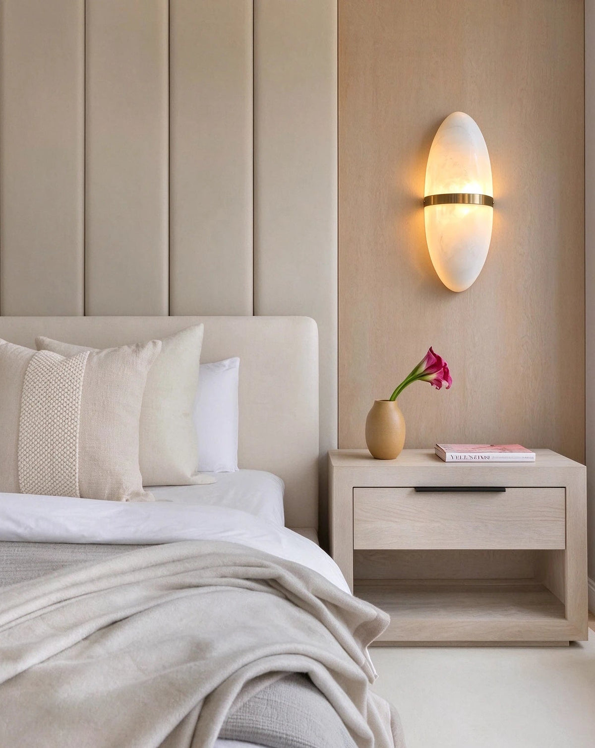 Modern Oval Alabaster Wall Sconce in Cozy Bedroom Setting