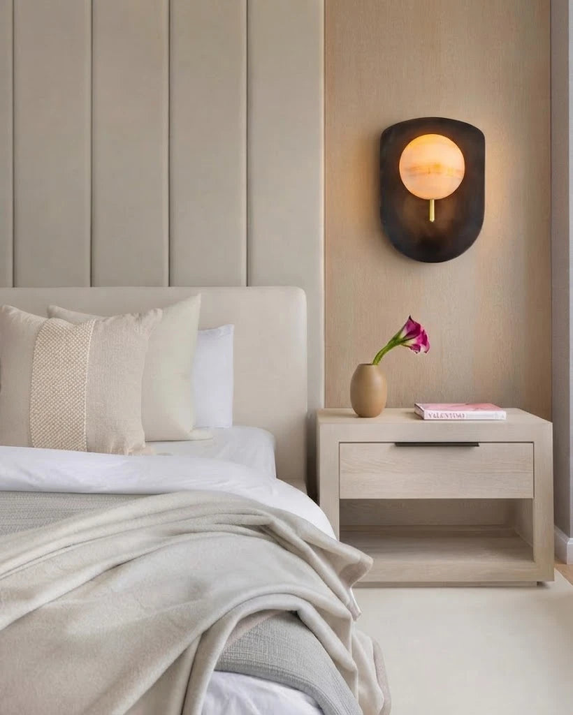 Modern Dark Shield Base Alabaster Wall Sconce in Cozy Bedroom Interior