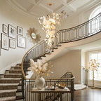 Modern Gold Branch Chandelier Along Grand Architectural Staircase