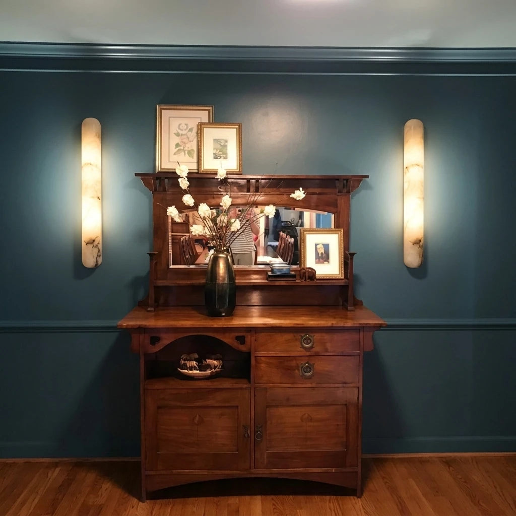 Modern Cylindrical Alabaster Wall Sconces Over Wooden Cabinet