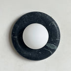 Illuminated Modern Black Marble Round Disc and Globe Wall Sconce Studio Shot