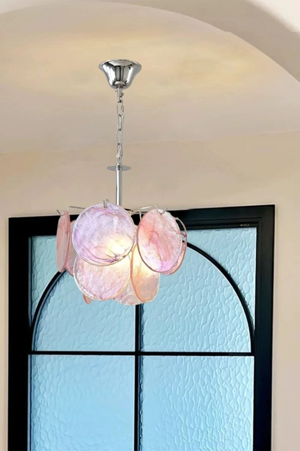 Illuminated Modern Colorful Petal Art Glass Pendant Light Against Window