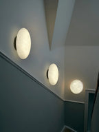 Modern Oval Alabaster Wall Sconces Along Hallway Corridor