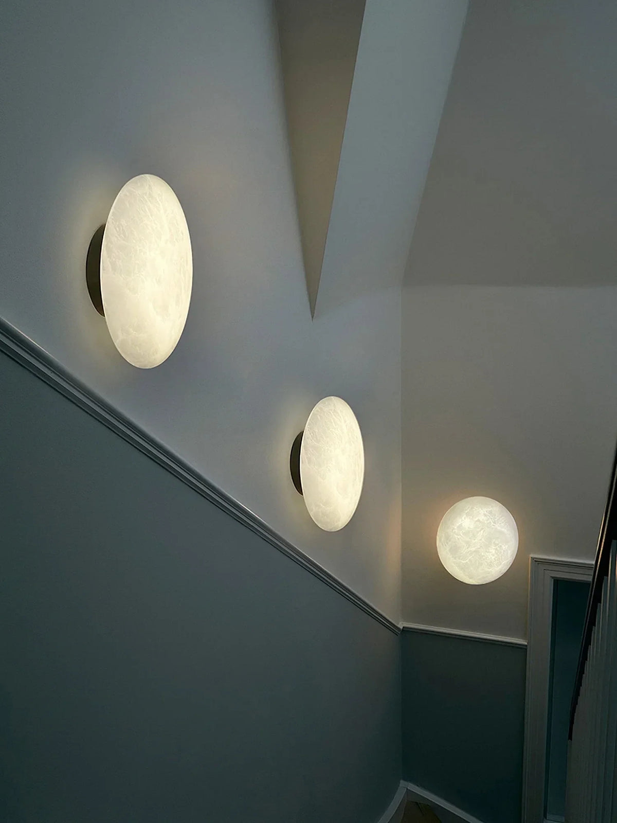 Modern Oval Alabaster Wall Sconces Along Hallway Corridor