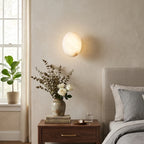 Modern Oval Alabaster Wall Sconce in Master Bedroom Setting