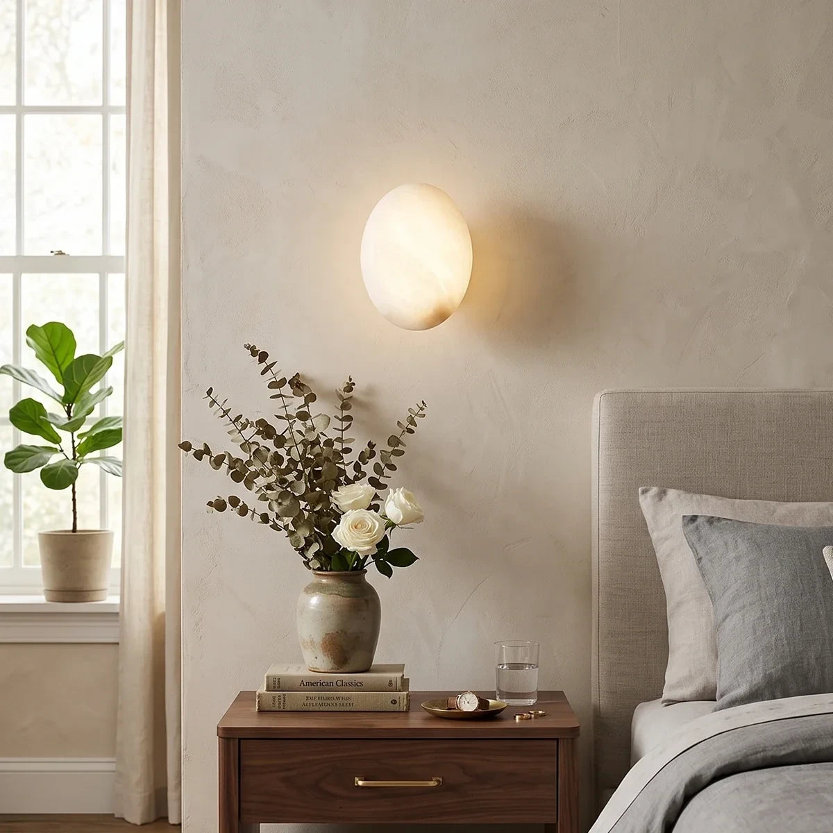 Modern Oval Alabaster Wall Sconce in Master Bedroom Setting