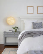 Modern Oval Alabaster Wall Sconce in Master Bedroom Setting
